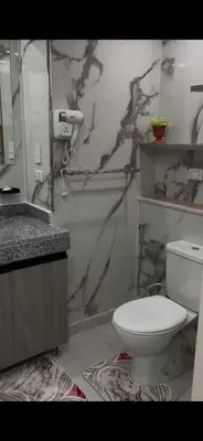 a bathroom with a white toilet and a sink at غرفة فندقية in Hurghada