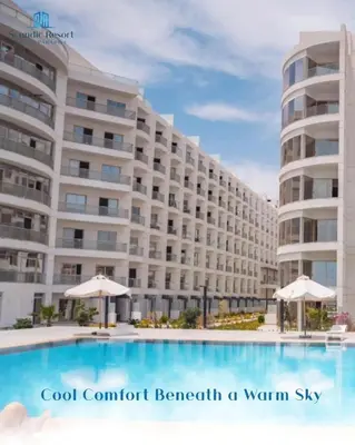 a hotel with a swimming pool in front of a building at غرفة فندقية in Hurghada