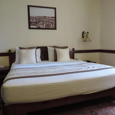 a bedroom with a large bed with white pillows at Luxor temple view in Luxor