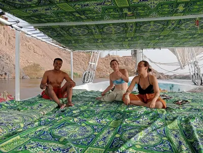 a group of people sitting on the bed of a boat at Taha nubian boat in Jazīrat Aswān