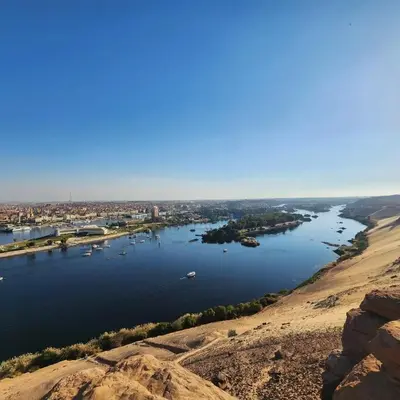 a view of a river with boats in the water at Taha nubian boat in Jazīrat Aswān