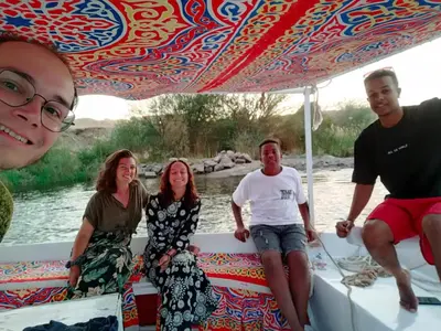 a group of people sitting on the back of a boat at Taha nubian boat in Jazīrat Aswān