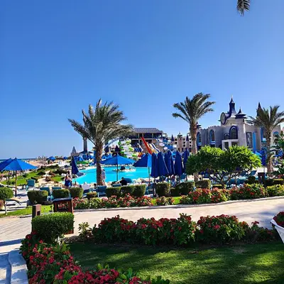 a resort with a pool and palm trees and a resort at Sahl Hasheesh Aparthotel Beachfront - SAHLHOMES in Hurghada