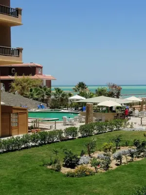 a view of a resort with a swimming pool at Hurghada Seafront Family Apartment with Pool View in Hurghada