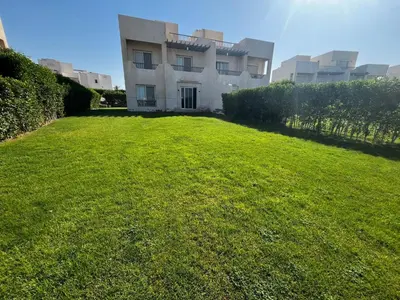 a large grassy yard in front of a building at El Gouna Joubal Villa #2 with Private Garden and Lagoon View in El Gouna