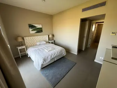 a small bedroom with a bed and a rug at El Gouna Joubal Villa #2 with Private Garden and Lagoon View in El Gouna