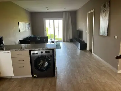 a kitchen with a washing machine in a room at El Gouna Joubal Villa #2 with Private Garden and Lagoon View in El Gouna