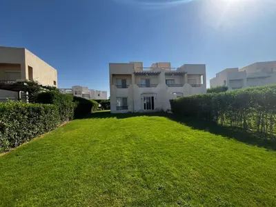 a grassy yard in front of a building at El Gouna Joubal Villa #2 with Private Garden and Lagoon View in El Gouna