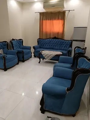 a living room with blue couches and a table at شقق وشاليهات ايجار in Hurghada