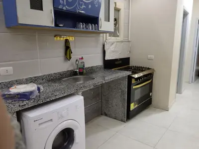a kitchen with a sink and a washing machine at شقق وشاليهات ايجار in Hurghada