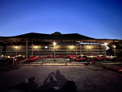 a stage with tables and chairs at night at Scenery Khalaf malky in Hurghada