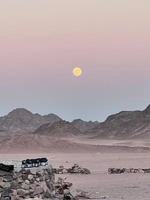 a yellow moon in the sky over the desert at Scenery Khalaf malky in Hurghada