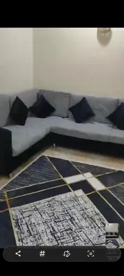 a couch with pillows and a rug in a living room at الغردقه الوفاء in Hurghada