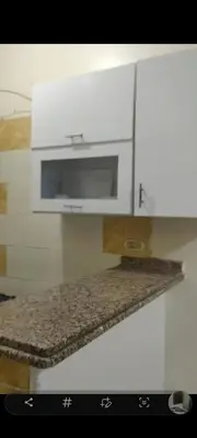 a kitchen with a counter top with a microwave at الغردقه الوفاء in Hurghada