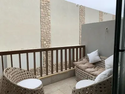 a balcony with two chairs and a couch at استوديو أنيق في الجونة in Hurghada