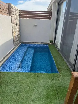 a swimming pool in the backyard of a house at شاليه بالي بمسبح خاص مدفأ in Hurghada