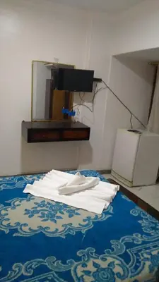 a pile of white towels on a bed with a mirror at Oscar Hotel Aswan \u4e2d\u570b\u4eba\u4e4b\u5bb6 in Aswan