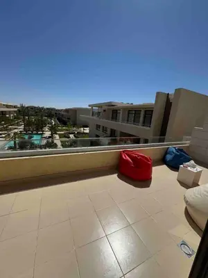 a balcony with red and blue pillows on a building at G Crips View in Hurghada