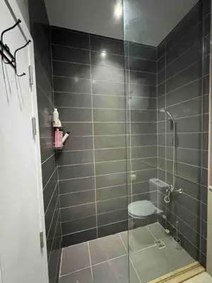 a bathroom with a glass shower with a toilet at G Crips View in Hurghada