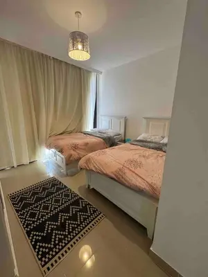 a bedroom with two beds and a chandelier at G Crips View in Hurghada