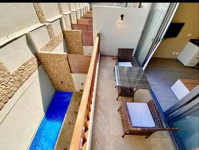 a group of stairs with chairs and a pool at استوديوا بالجونه in Hurghada