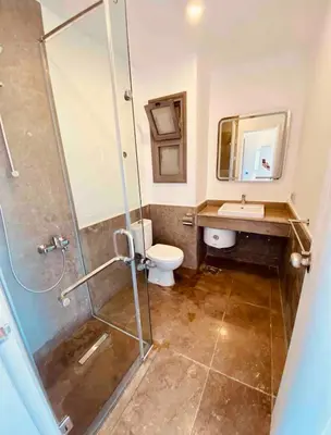a bathroom with a shower and a toilet and a sink at استوديوا بالجونه in Hurghada