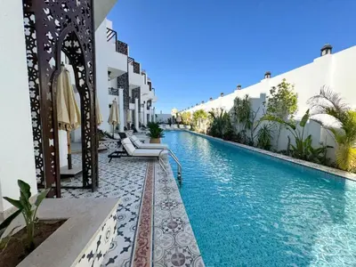 a swimming pool in the middle of a building at Arabian Suites by Imperial 1 bed Apartment in Hurghada