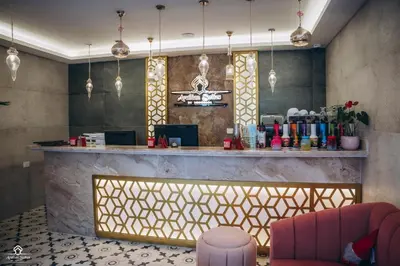 a lobby with a bar with pink chairs and a counter at Arabian Suites by Imperial 1 bed Apartment in Hurghada