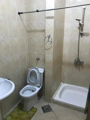 a bathroom with a toilet and a tub and a sink at Premier group in Hurghada