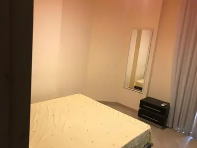 a small bedroom with a bed and a mirror at Premier group in Hurghada