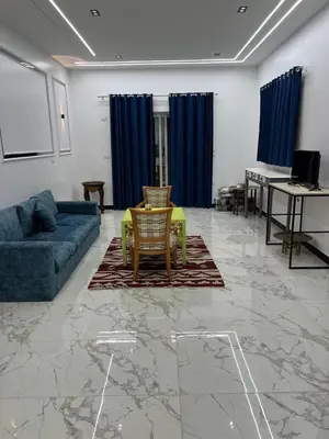 a living room with a couch and a table at Jasmine Villa in Jazīrat al ‘Awwāmīyah