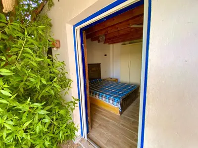 a door to a room with a bed in it at Jasmine Villa in Jazīrat al ‘Awwāmīyah