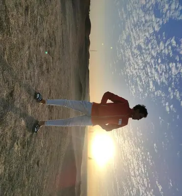 a man standing on a skateboard in front of the sun at High mountain in Luxor