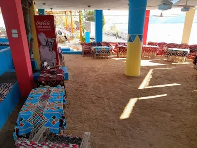 a room with tables and chairs in a building at ISIS Hostel in Aswan