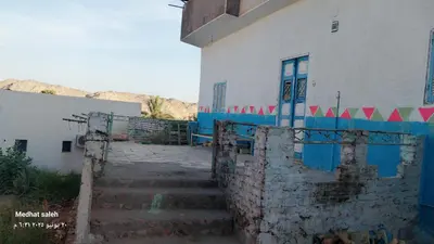 a building with a staircase leading up to a door at ISIS Hostel in Aswan
