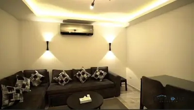 a living room with a couch and a tv at Selena bay 006 in Hurghada