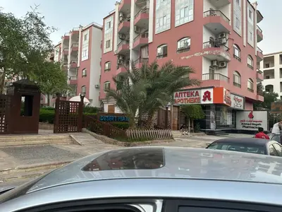 a car parked in front of a pink building at Desert Pearl Studio Retreat in Hurghada