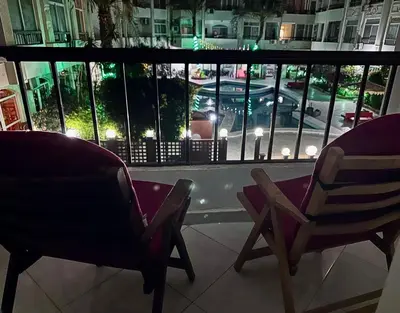 two chairs on a balcony with a view of a street at Desert Pearl Studio Retreat in Hurghada