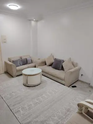 a living room with a couch and a coffee table at Family apartment in front of the sea in Hurghada