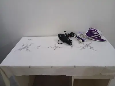 a white table with a pair of glasses on it at Family apartment in front of the sea in Hurghada