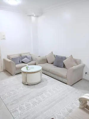 a living room with two couches and a coffee table at Family apartment in front of the sea in Hurghada