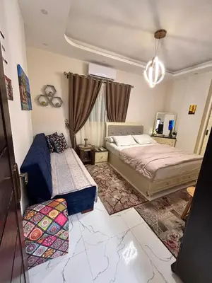a bedroom with two beds and a chandelier at studio for rent in Hurghada