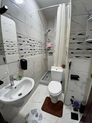 a bathroom with a white toilet and a sink at studio for rent in Hurghada