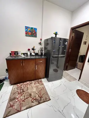 a kitchen with a refrigerator and a counter top at studio for rent in Hurghada