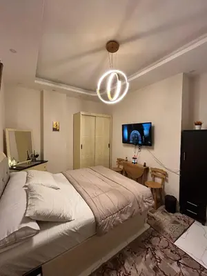 a bedroom with a large bed and a table at studio for rent in Hurghada