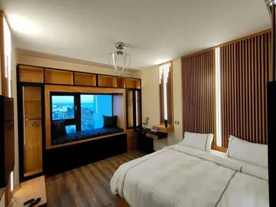 a bedroom with a large bed and a large window at Chalet in Hurghada