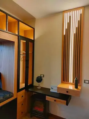 a room with a bed and a desk and a window at Chalet in Hurghada