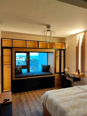 a bedroom with a large window with a view at Chalet in Hurghada