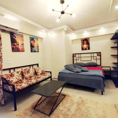 a bedroom with two beds and a couch at Princess Resort, Hurghada in Hurghada