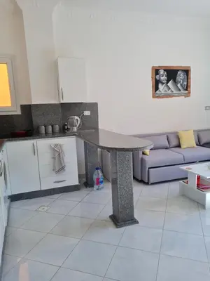 a kitchen with a table in the middle of a room at Oasis Resort Soraya - 2 bed apt, recently renovated and fully furnished with pool views in Al Ahyaa Hurghada Egypt in Hurghada